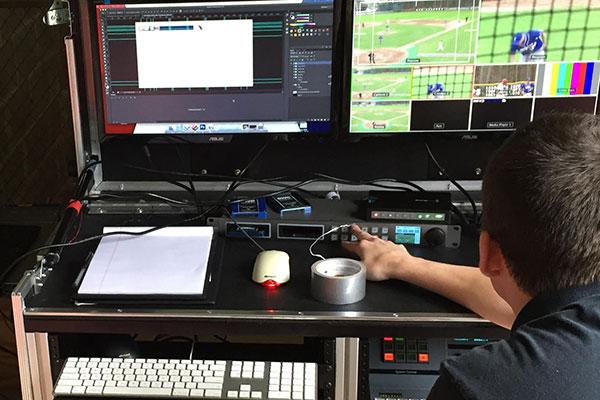 student working at baseball game
