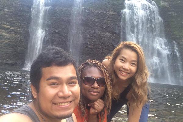 Students taking selfie by waterfall