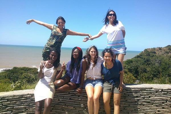 Students in front of beach in Brazil