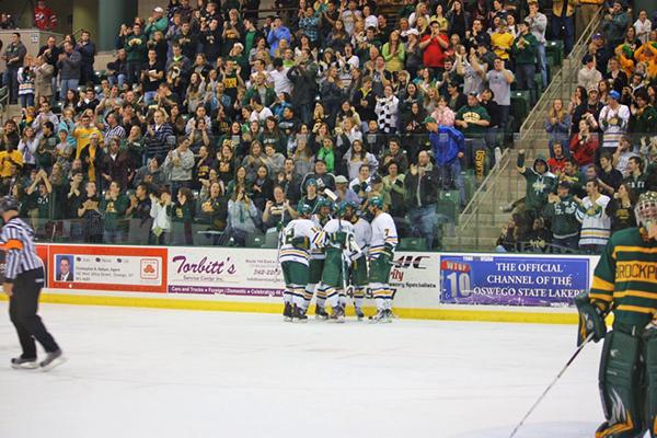 Hockey team celebrating after goal against Brockport