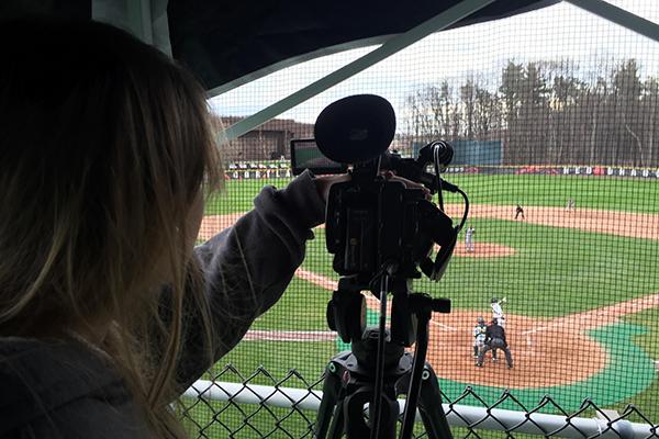 Student filming baseball game