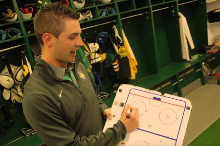 Jonathon holding hockey white board