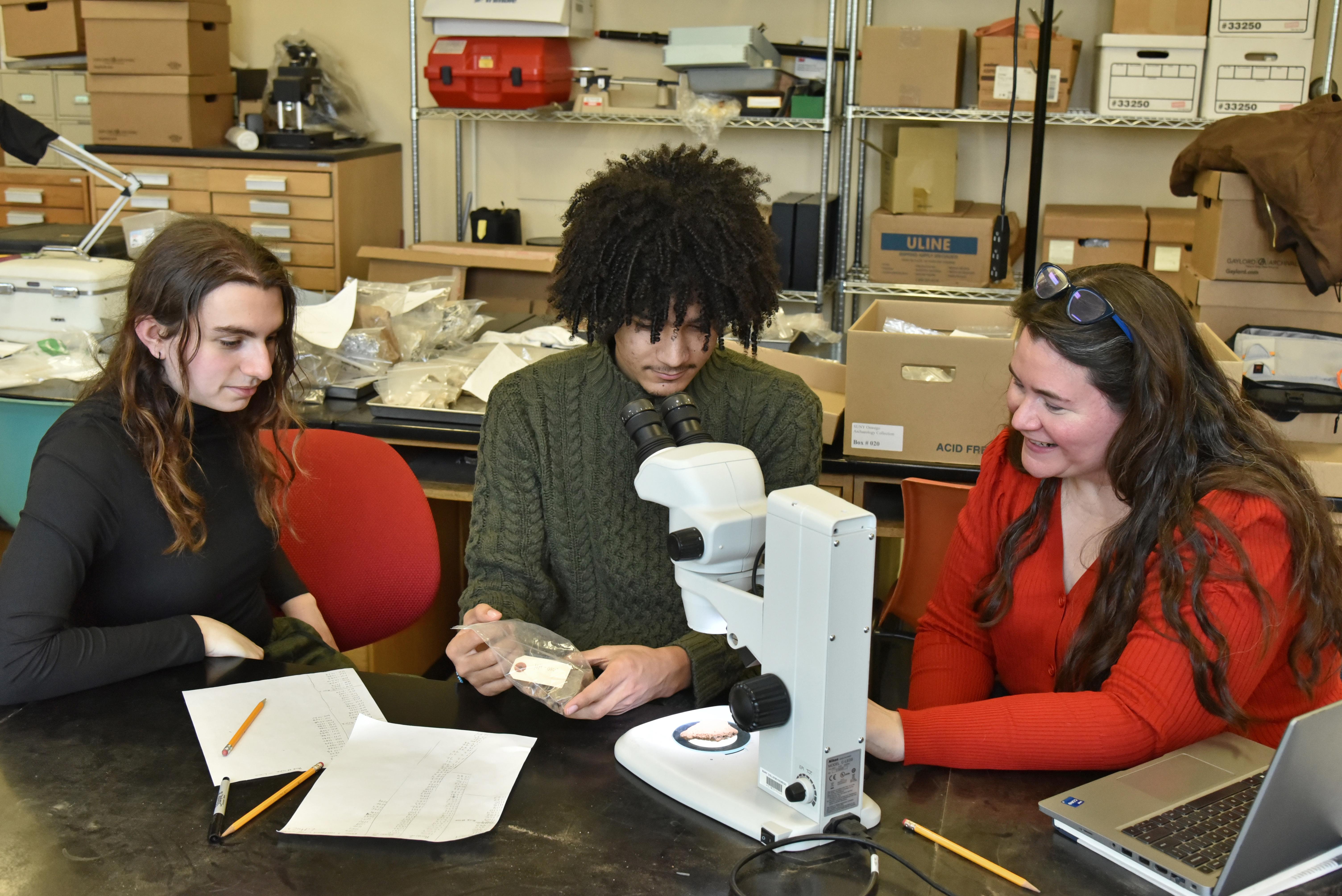 Anthropology faculty member Alanna Ossa works with students in a lab