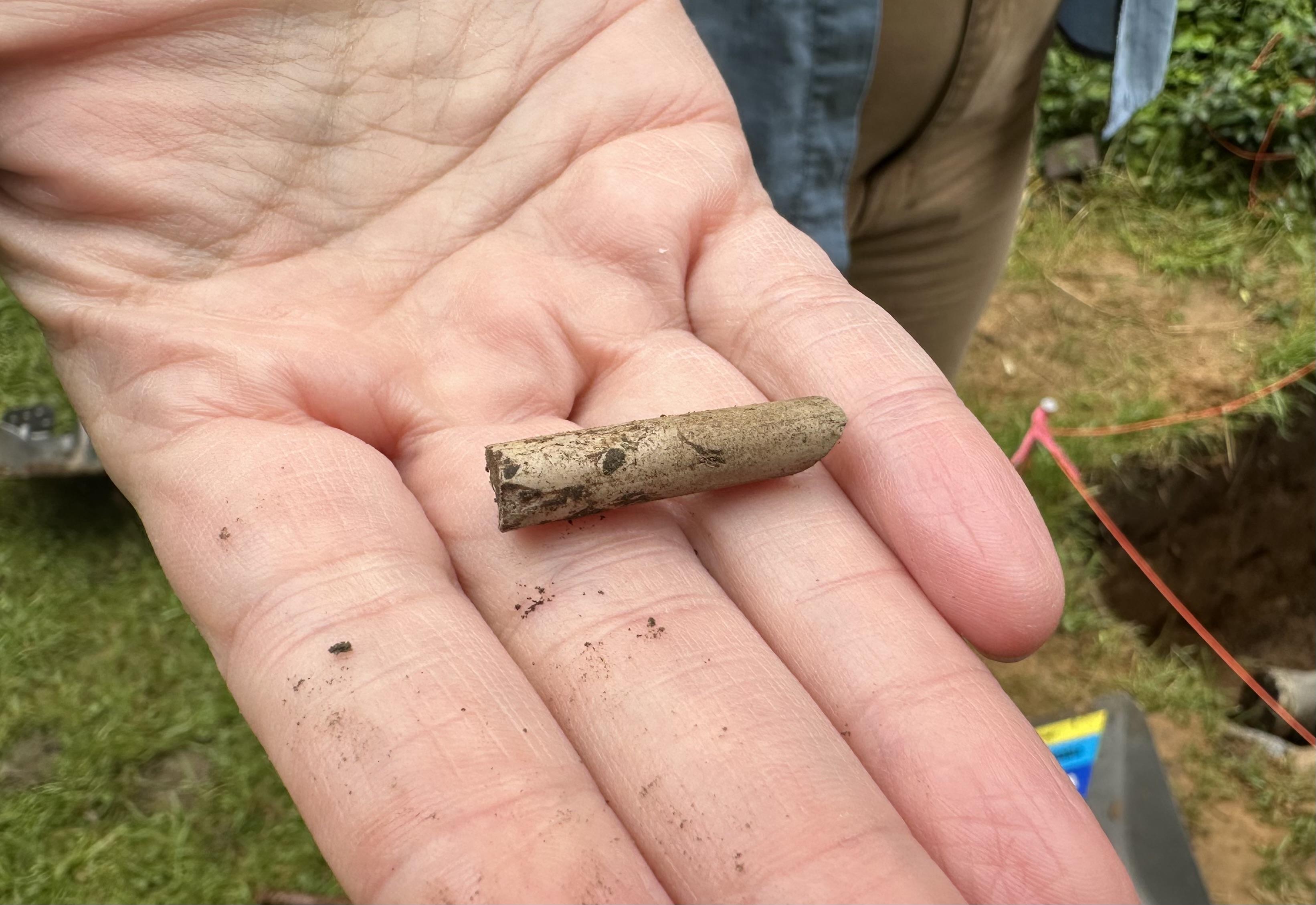 Piece of clay pipe found at archaeological dig site.