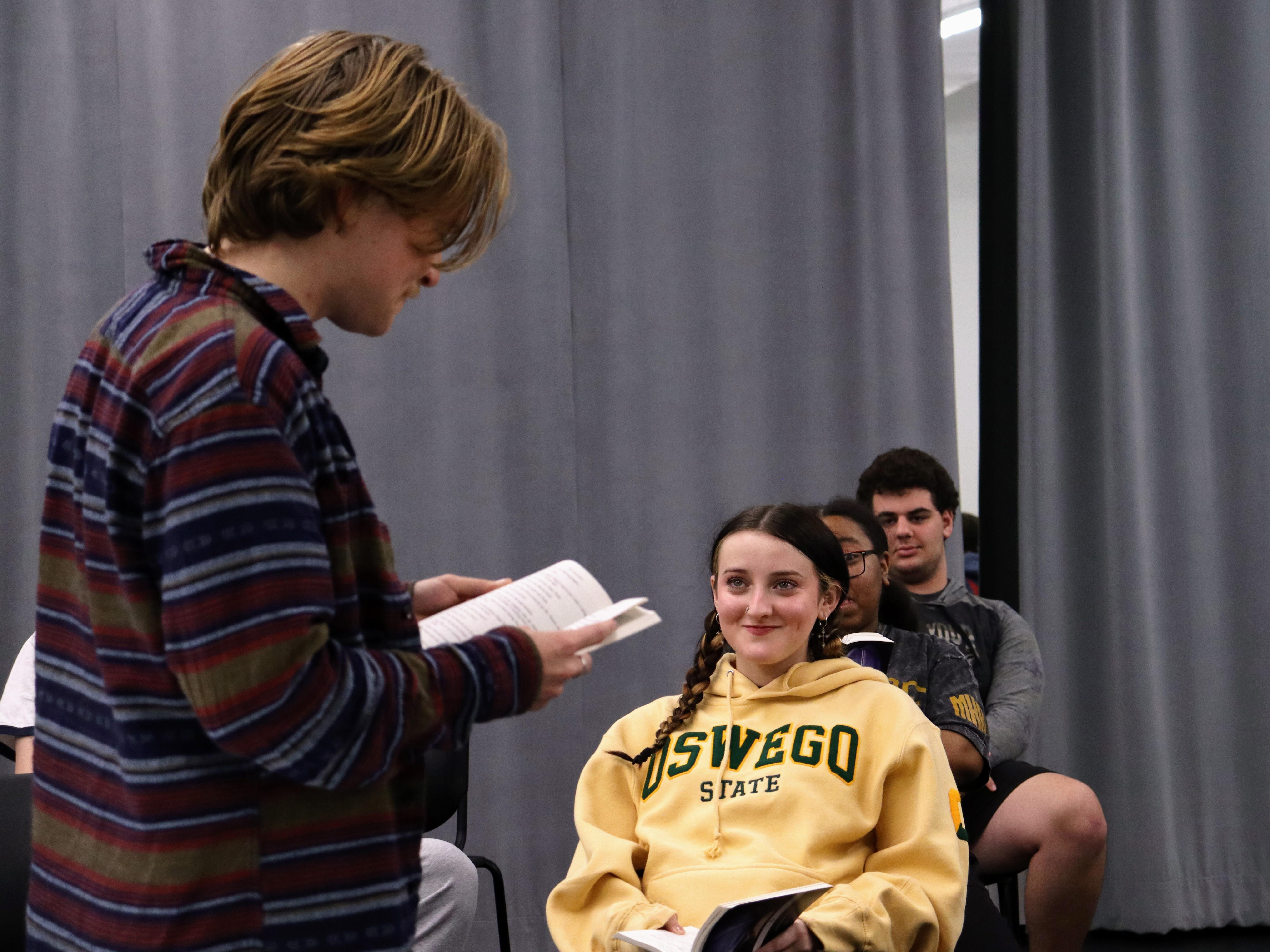 The SUNY Oswego production of  “John Proctor is the Villain” depicts teenangers exploring hardships while studying the classic novel “The Crucible." Student performers include Wells Liscomb (standing and reading) and Kamdyn Miller (front and center).