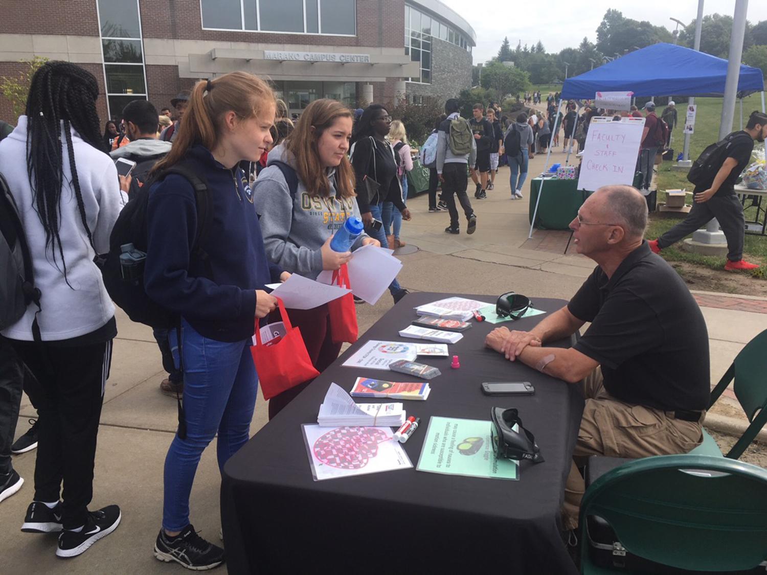 Robert Lighthall of the Oswego County Sheriff's Department speaks with students at a previous Mental Health and Wellness Fair