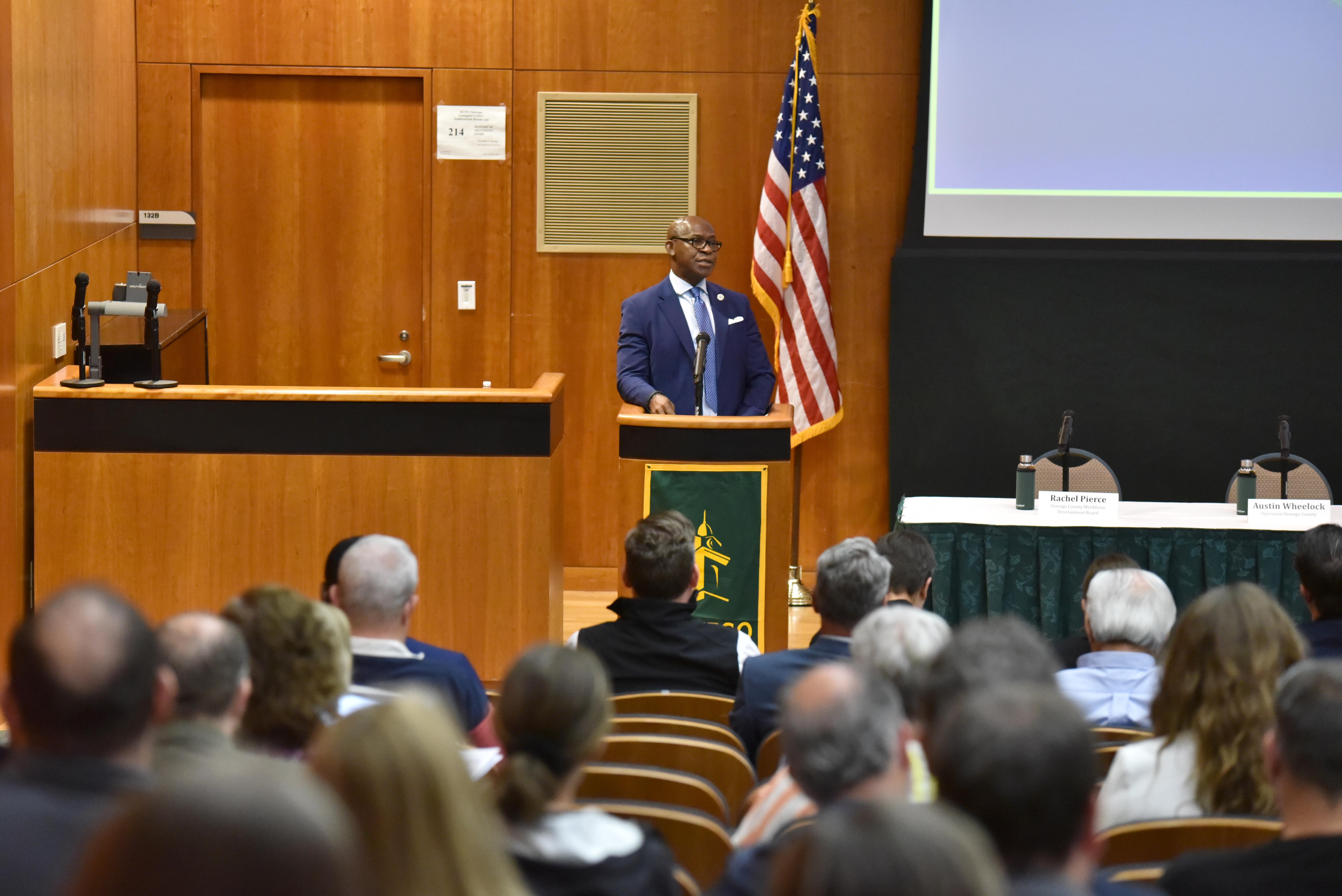 SUNY Oswego President Peter O. Nwosu, who chairs the Oswego County Micron Strategy Steering Committee, welcomes attendees to the committee's inaugural annual summit.
