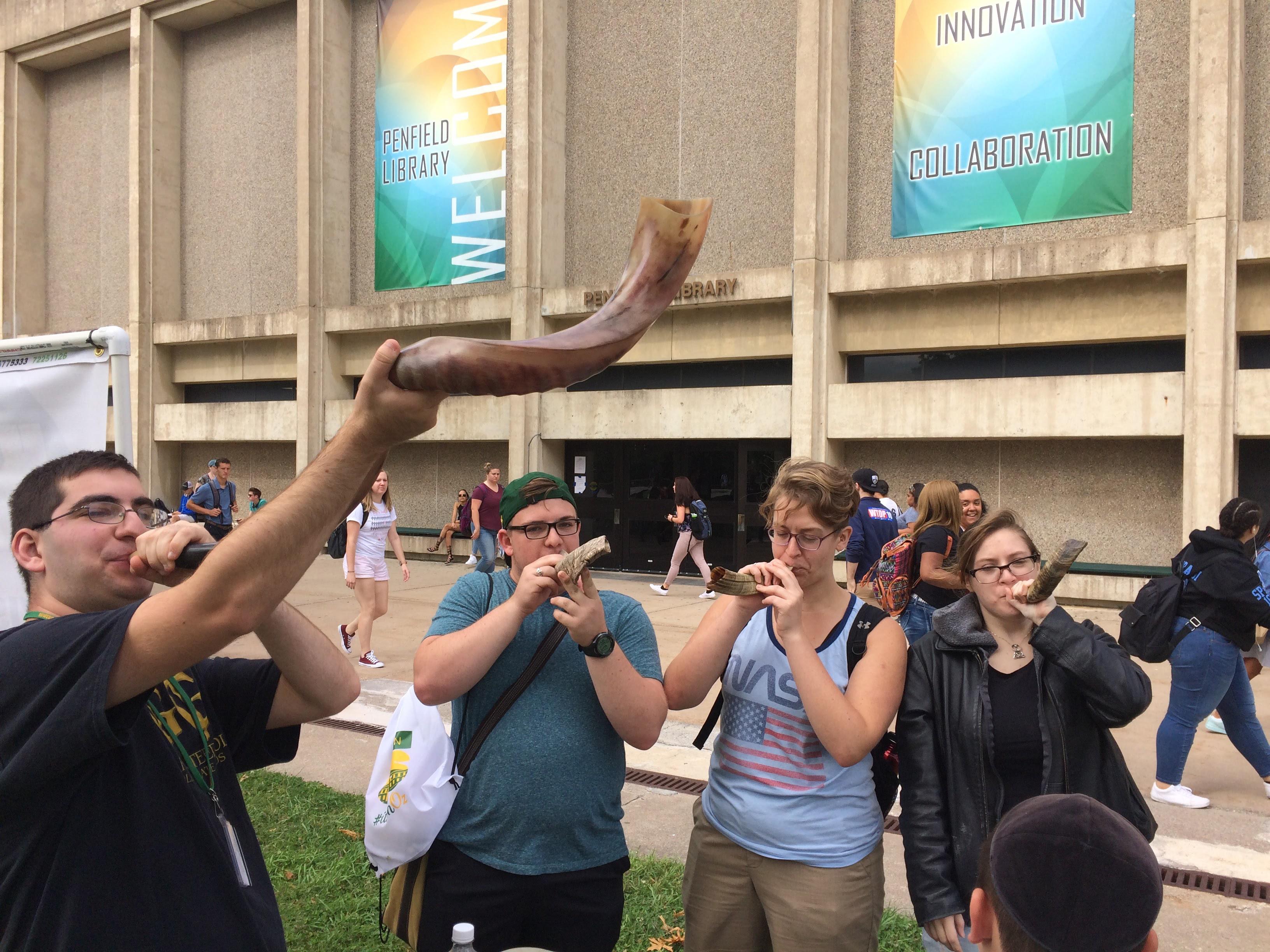 Students of Jewish Life at SUNY Oswego with shofars, which are traditional ram-horn trumpets used at Rosh Hashanah and Yom Kippur. 