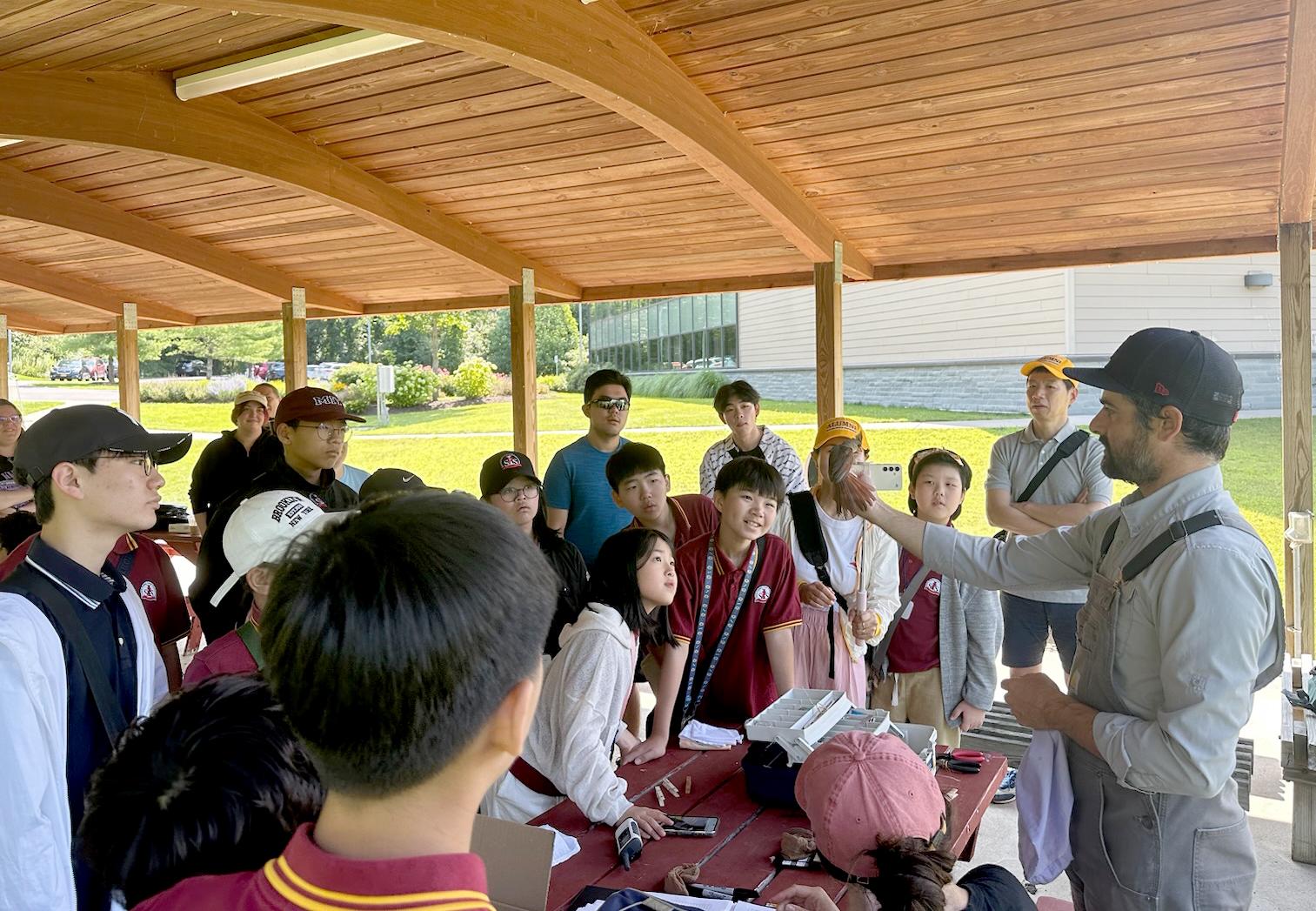 Biological science faculty member Daniel Baldassarre provides an ornithology lesson to visiting students from South Korea