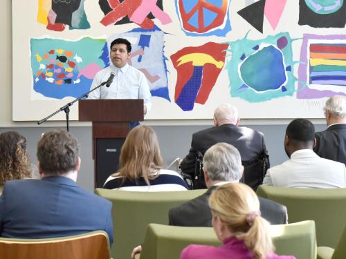 Shown speaking at the May dedication of SUNY Oswego's Maraviglia Atrium, Bryan Diaz-Ximello was one of five 2023-24 winners of the Carey Gabay Scholarship Program