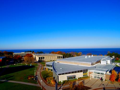 Aerial view of campus with fall foliage and Lake Ontario