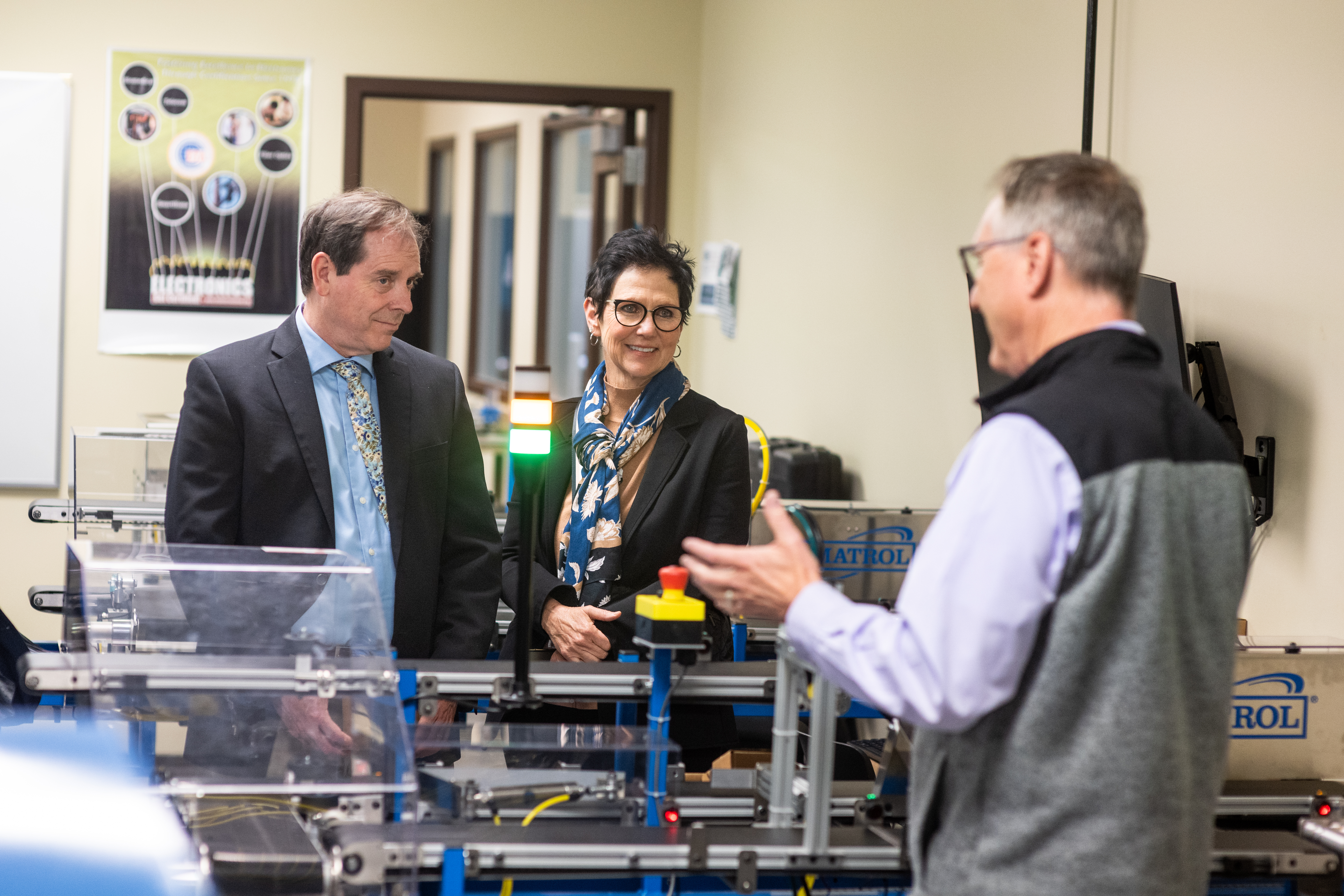 SUNY Oswego leaders met with colleagues from College of Western Idaho University to discuss their partnerships with Micron. Robert Novak (at right), chair of the Engineering Department for College Western Idaho University, shows some of the developed technology to SUNY Oswego's Provost and Vice President for Academic Affairs and Vice President for University Advancement Mary Canale. 