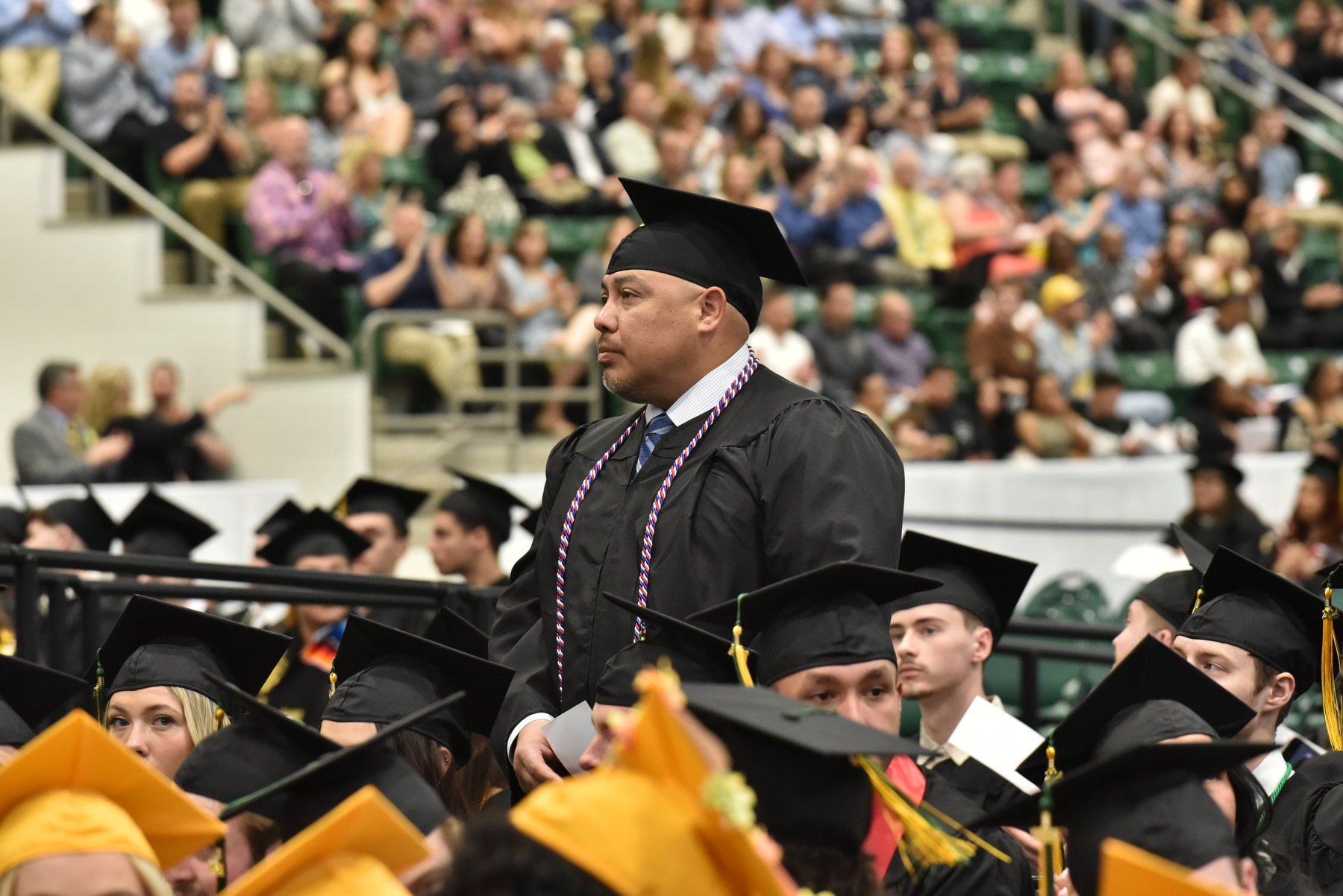 Military service members and veterans are recognized by Provost Scott Furlong at the beginning of each Commencement ceremony. Pictured is Jerry Mosqueda, a graduate in the School of Business, as he stands in recognition of his valued service.