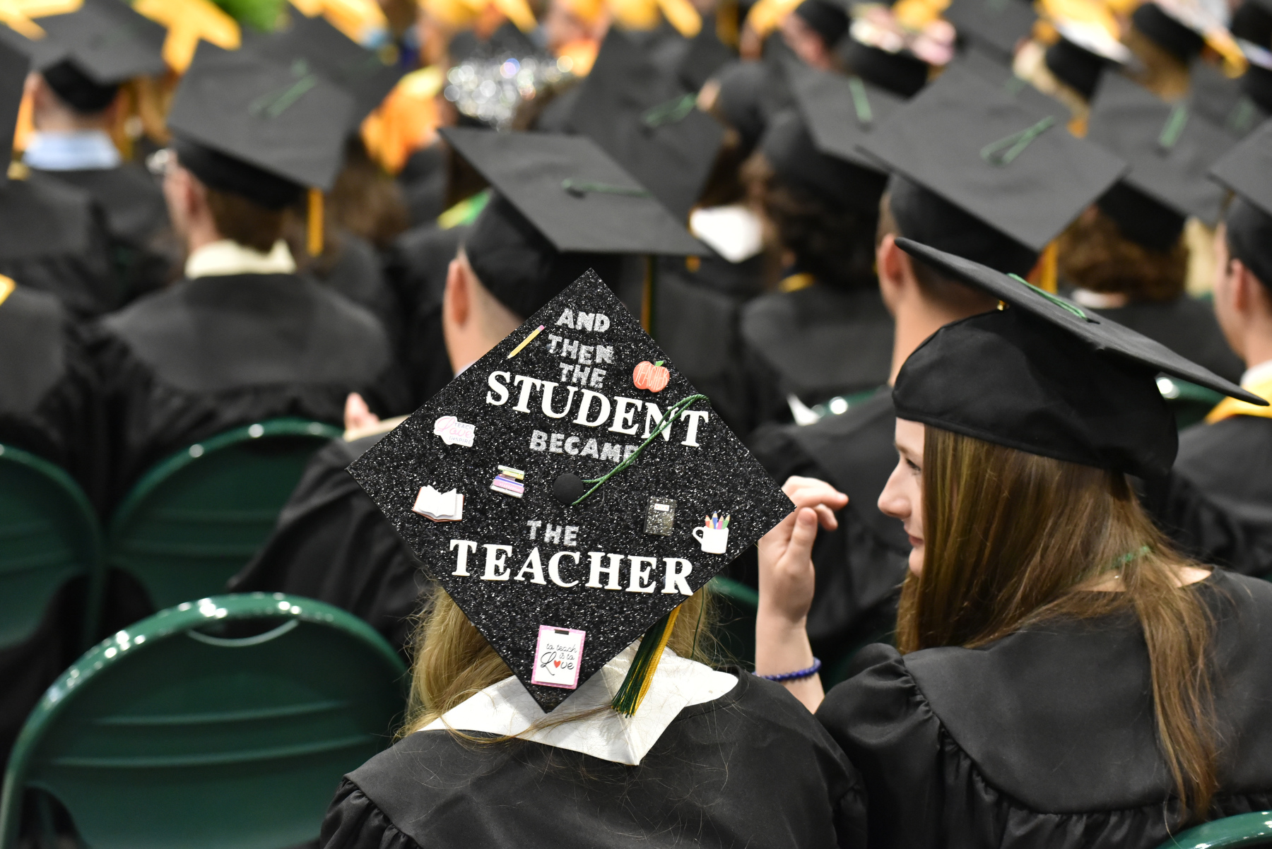 A School of Education graduate celebrates her achievement and future with mortarboard decorations. 