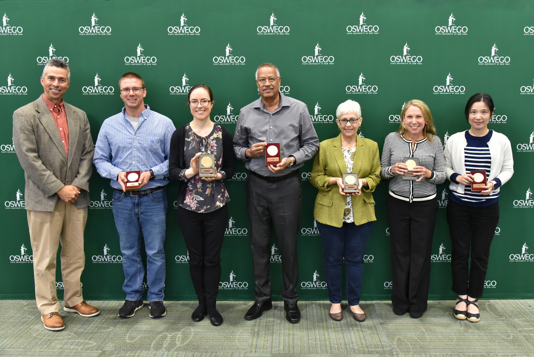 From left, Associate Provost for Research and Sponsored Programs Bill Bowers congratulates medal winners Nicholas Sard, Silver Medal; Kristen Haynes, Bronze Medal; Kamal Mohamed, Silver Medal; Joanne O'Toole, Gold Medal; Michelle Storie, Gold Medal; and Sien Hu, Silver Med