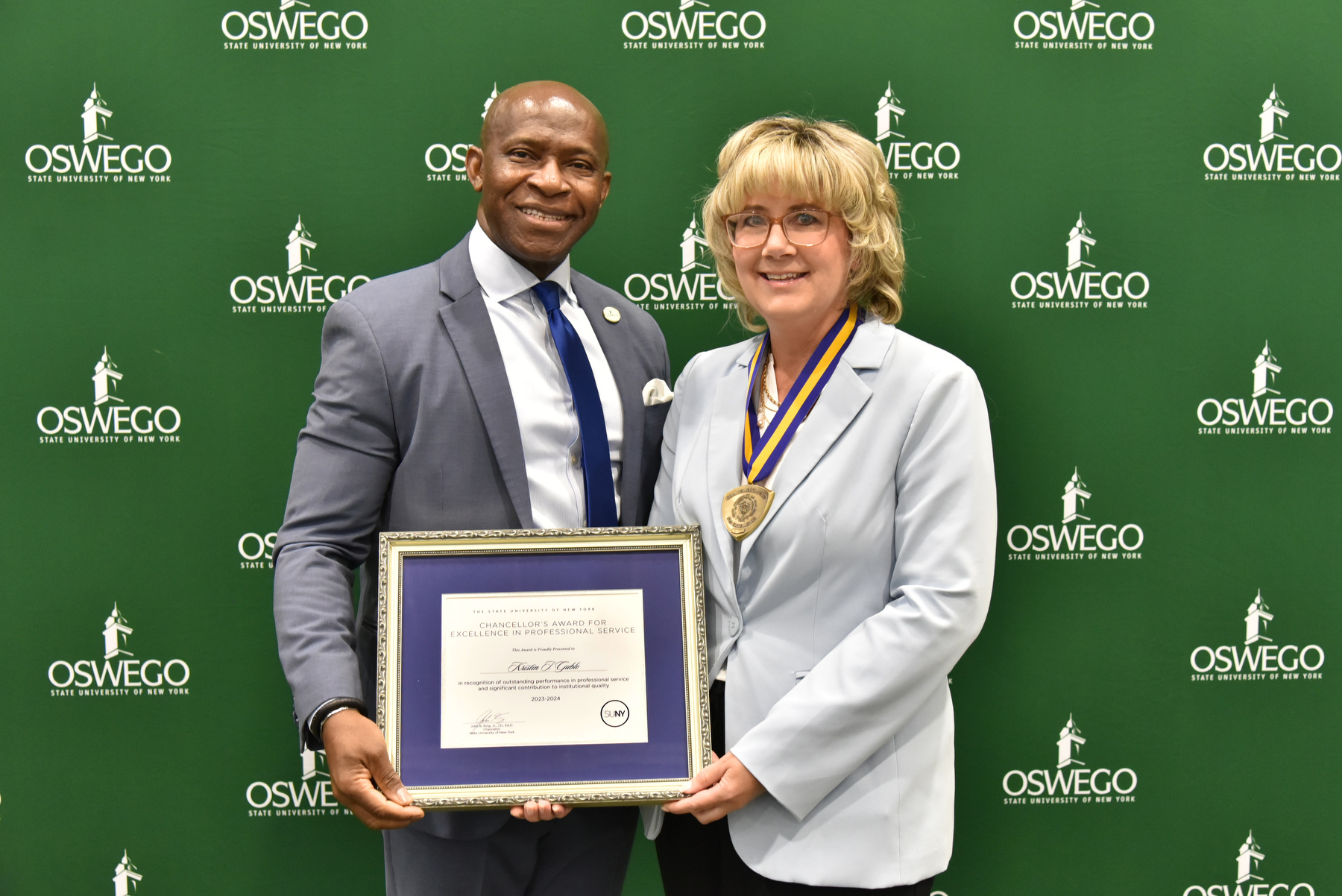 Kristin Gublo, instructional support specialist for the Chemistry Department, receives her Chancellor's Award for Excellence in Professional Service and congratulations from President Peter O. Nwosu at the Opening Breakfast. Watch Oswego Today for a full story on her award. 