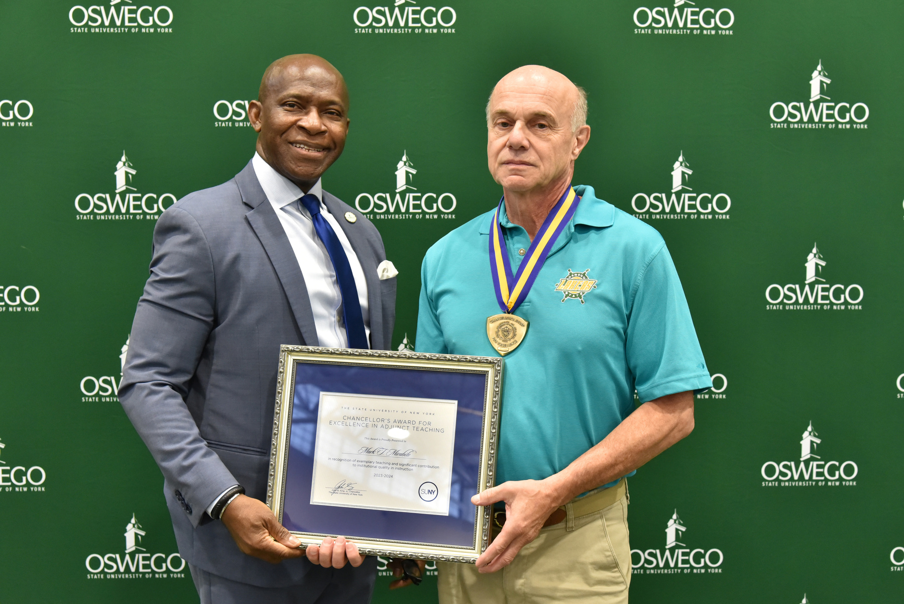 Psychology faculty member Mark Mirabito receives his Chancellor's Award for Excellence in Adjunct Teaching and congratulations from President Peter O. Nwosu at the Opening Breakfast. Watch Oswego Today for a full story on his award.