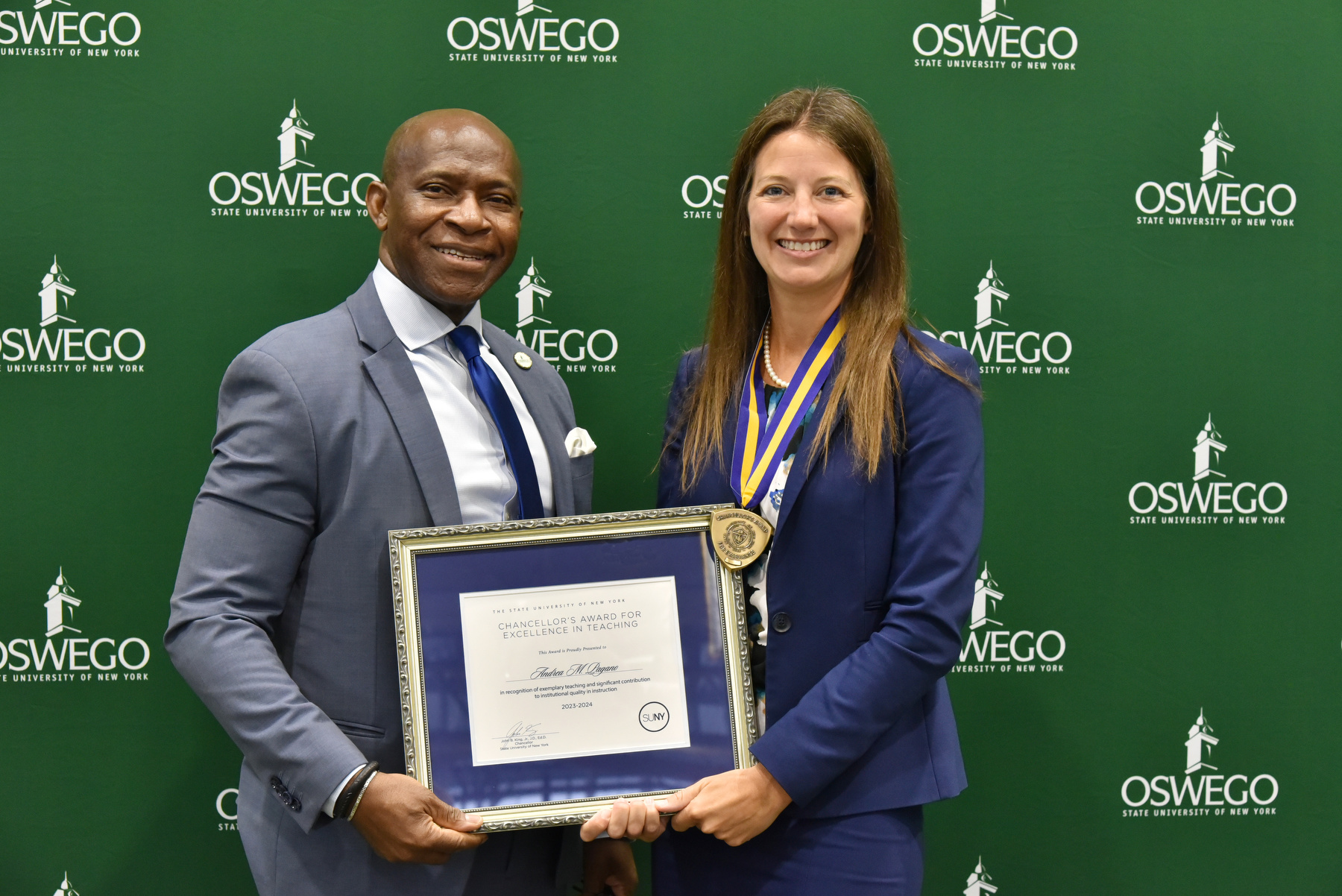 Accounting faculty member Andrea Pagano receives her Chancellor's Award for Excellence in Teaching and congratulations from President Peter O. Nwosu at the Opening Breakfast. Watch Oswego Today for a full story on her award.