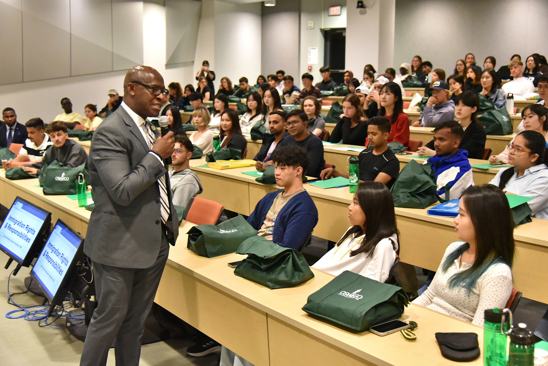 President Peter O. Nwosu welcomes a room filled with new international students during their orientation program Aug. 21 in the Shineman Center.