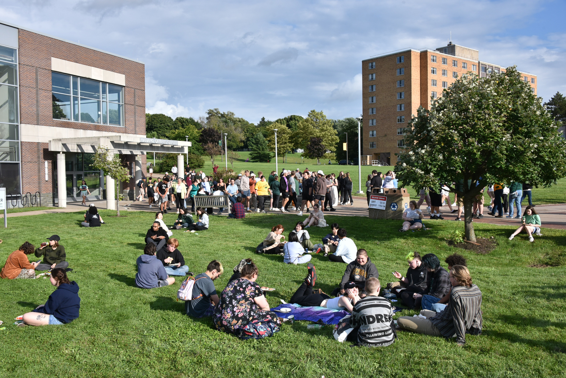 The annual campus Opening Picnic on Aug. 21 unfolded under perfect weather this year greets students, faculty and staff to the new semester in the week prior to the start of classes. Groups of students enjoy expertly prepared food and beverages in a leisurely setting between Marano Campus Center and Penfield Library.