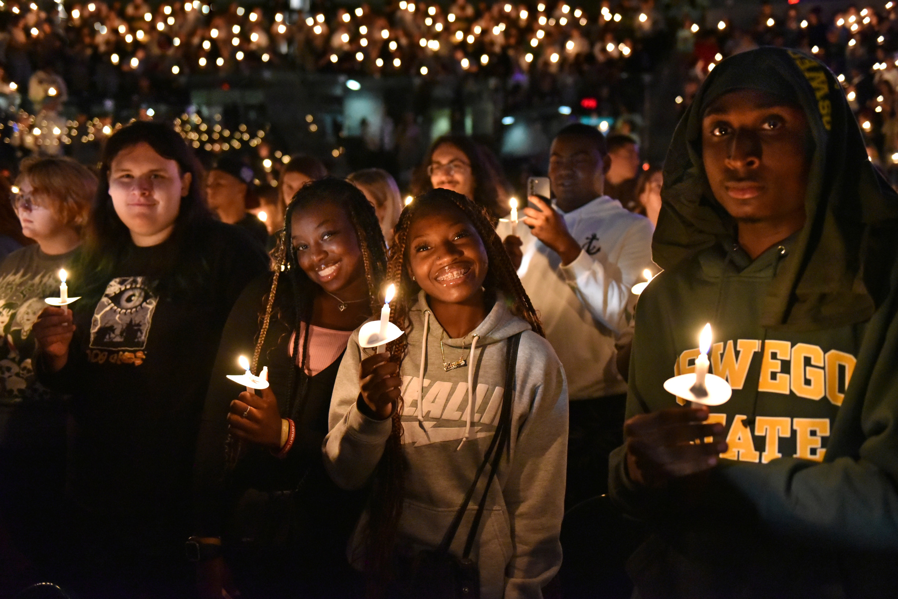 Students hold candles during the Welcoming Torchlight Ceremony, which welcomes the newest Lakers into the SUNY Oswego family.