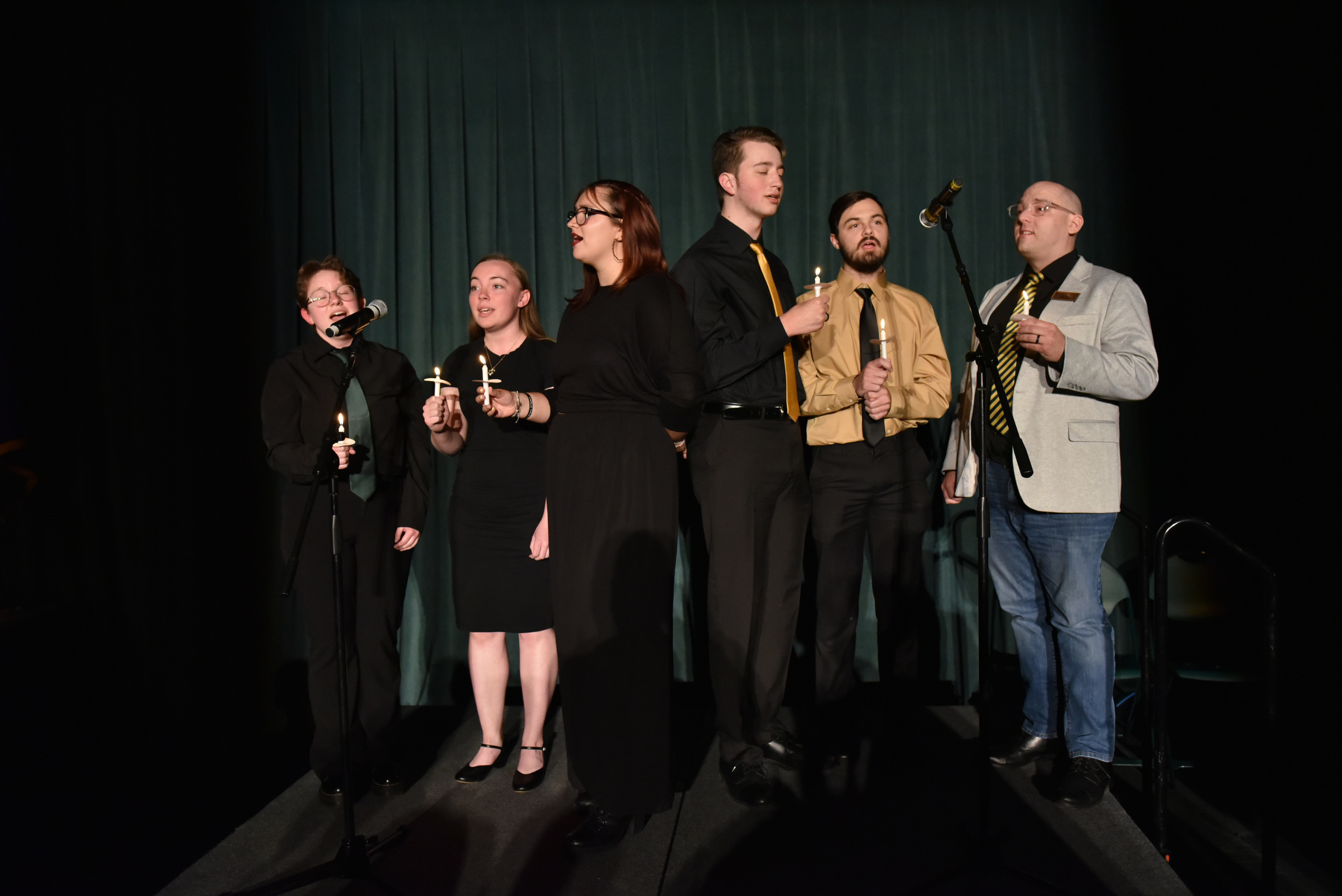 Members of the university’s State Singers sing the university’s Alma Mater at the conclusion of the Welcoming Torchlight Ceremony.