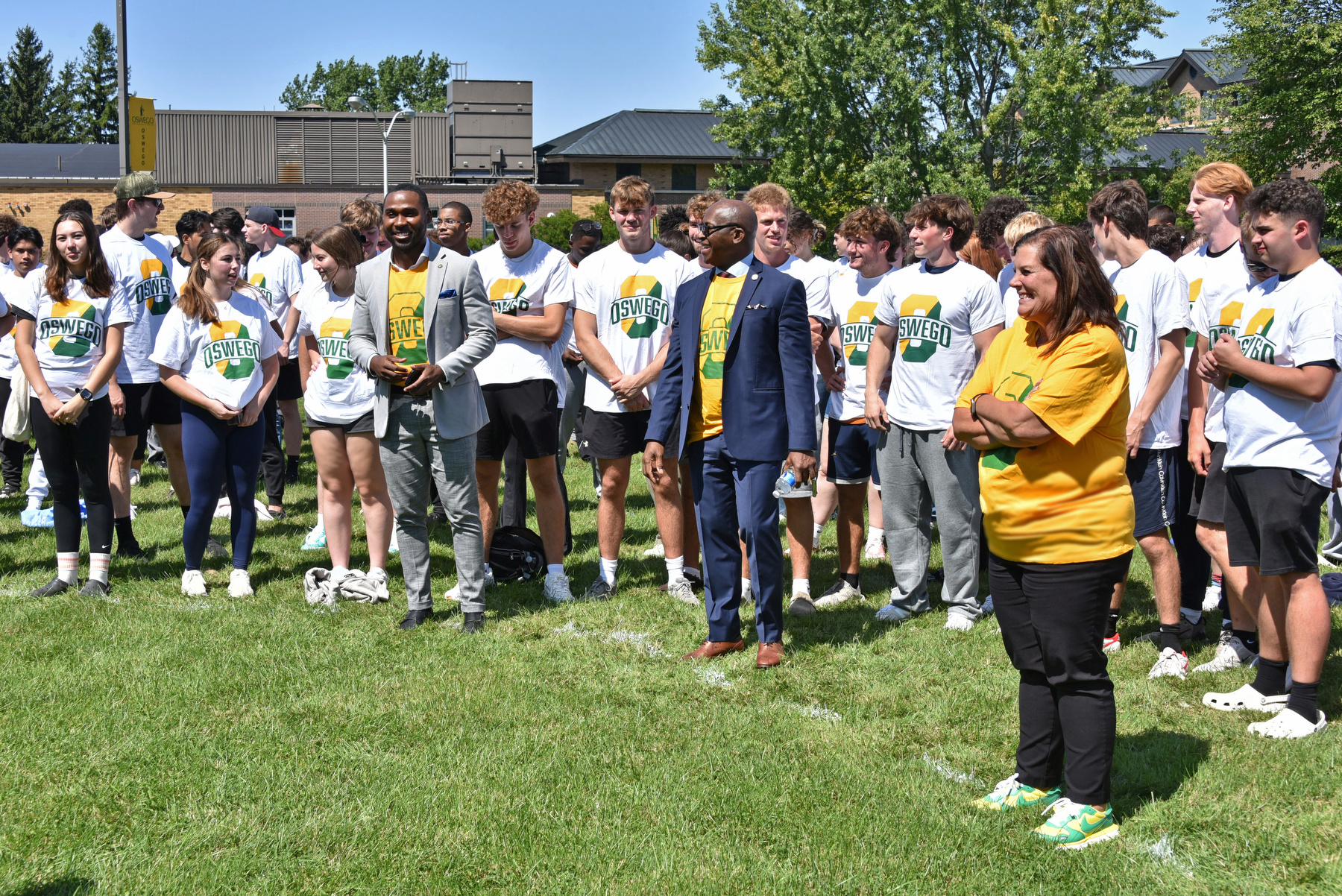 President's Cabinet members (from left) Jamal Coleman, director of operations in the Office of the President; President Peter O. Nwosu; and Victoria Furlong, vice president for administration and finance, and many other college administrators, faculty and staff help coordinate the hundreds of students Aug. 22 for the annual "O" photo on the Lee Hall soccer field.