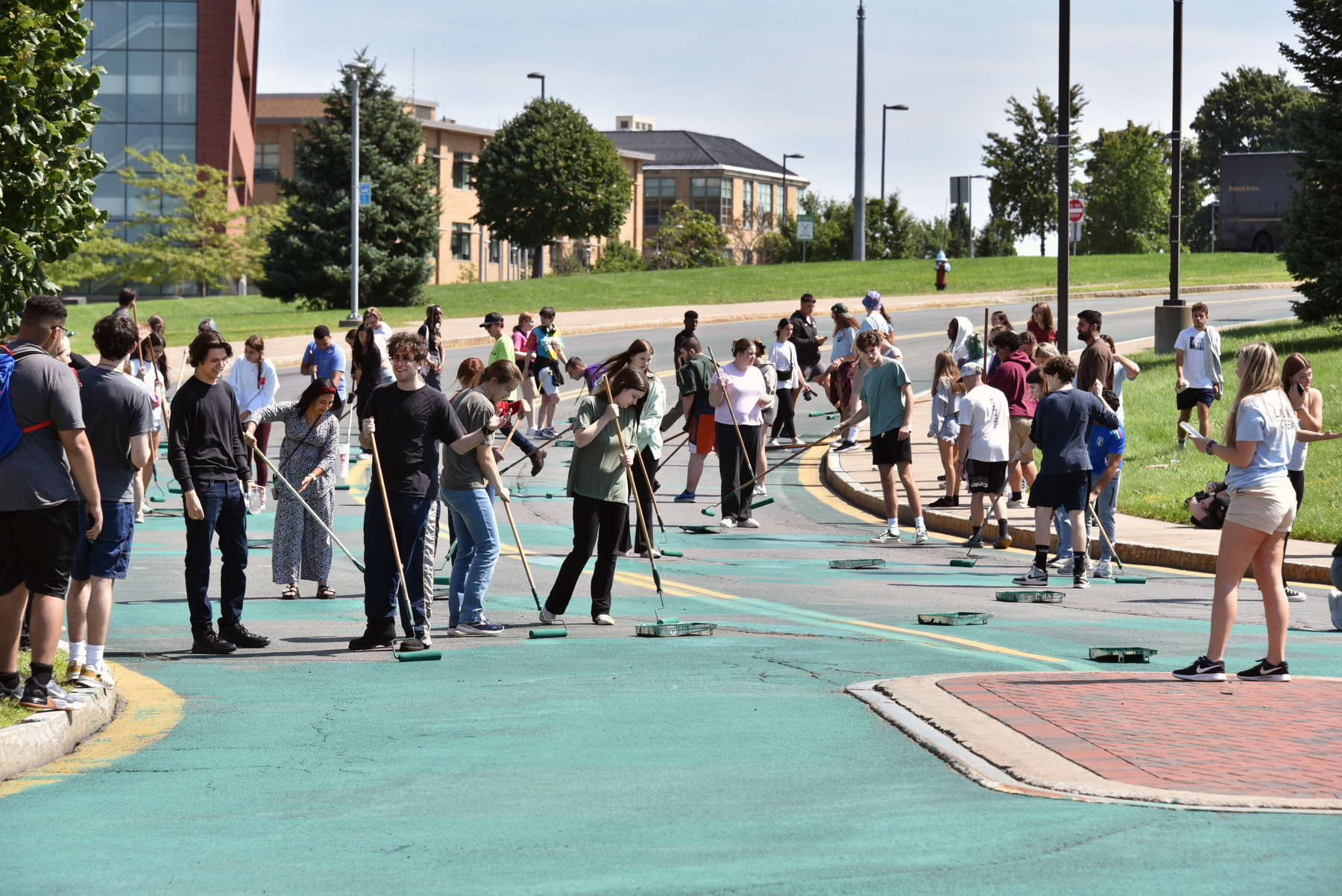 Incoming students and others gathered at the Marano Campus Center bus loop Aug. 22 for the third annual Paint the Road Green event, part of opening week for the newest Lakers.