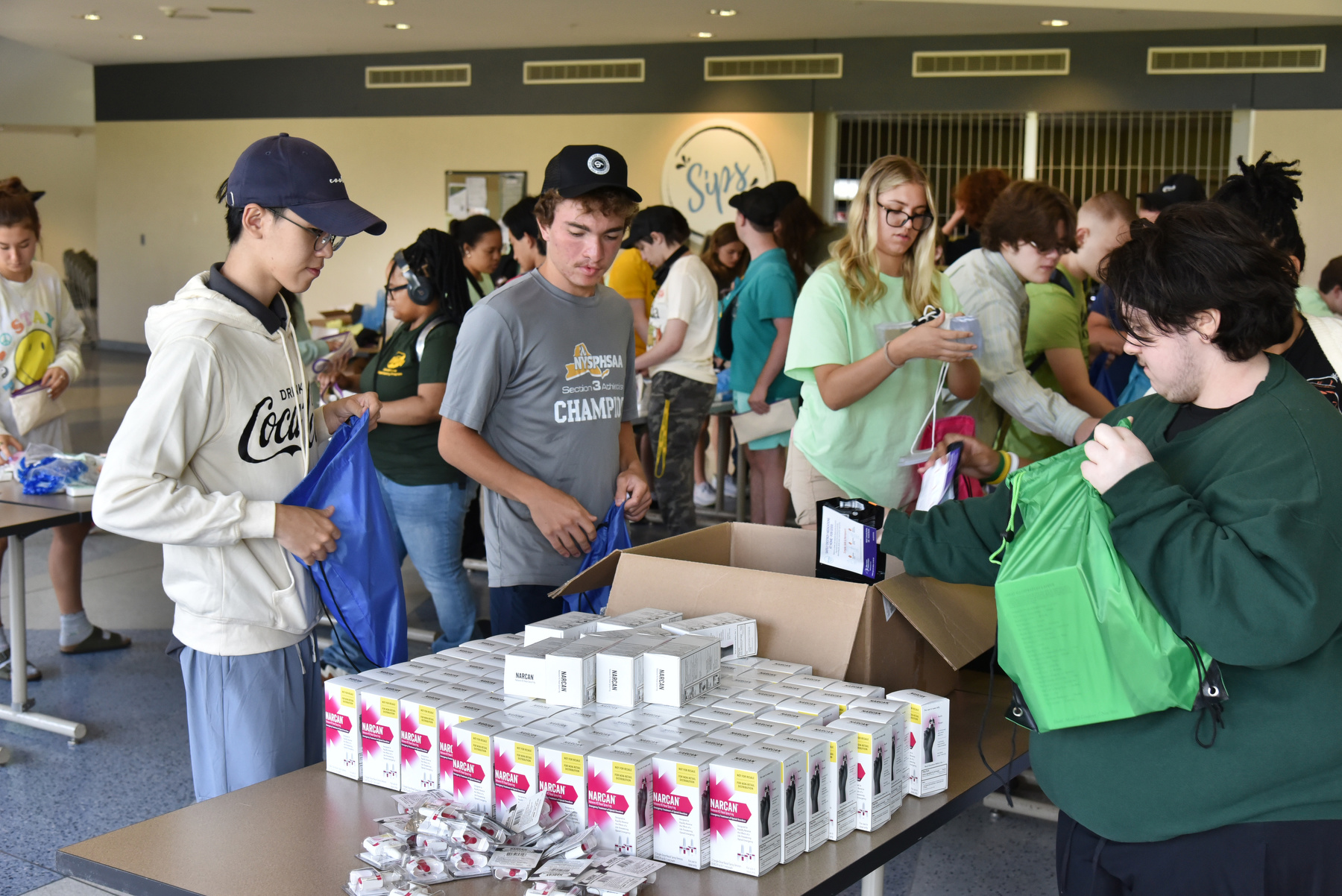 New students worked with local agencies in an Oswego Serves day of service just before the start of the semester. Students assisted with projects such as a Habitat for Humanity home construction, Harm Reduction Kits with Oswego County Opportunities and more. Pictured are new students filling kits Aug 24 in Marano Campus Center food and activities court, organized by the Student Engagement and Leadership Office and the Student Association.