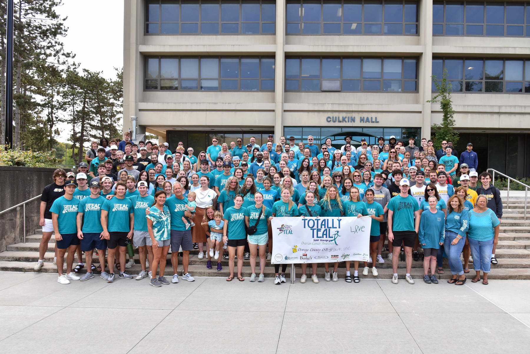 The campus community gathered Sept. 16 for the National Ovarian Cancer Awareness Month group photo at Culkin Hall followed by a walk around the lagoon in remembrance of the late Mary Gosek. SUNY Oswego's SEFA (State Employees Federated Appeal) campaign continues the Totally Teal campaign for fundraising and awareness in this annual event in September.