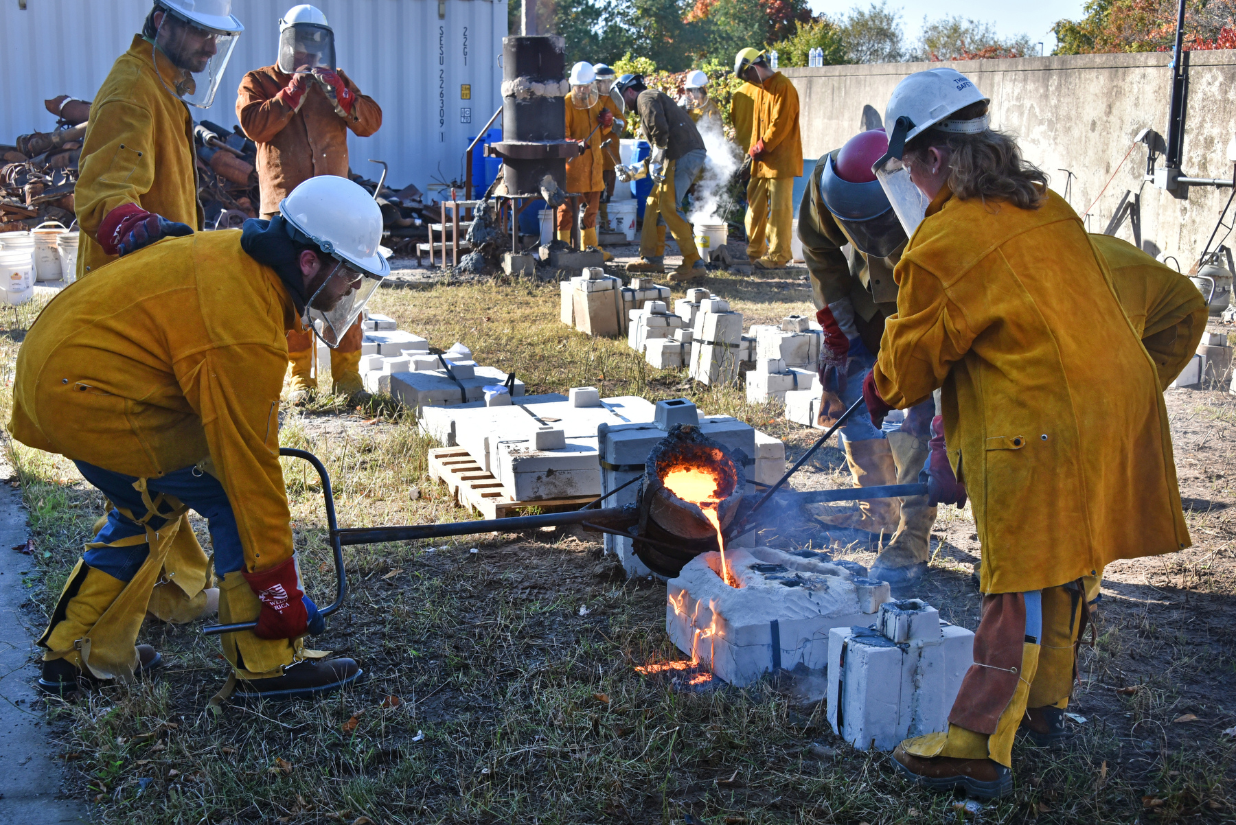 Students and faculty in the Department of Technology and the Department of Art and Design once again collaborated in the popular Iron Pour, this year titled Festival of Fire. Scrap iron is heated in a coke-fired kiln until molten then poured into molds crafted by creative hands who attended.