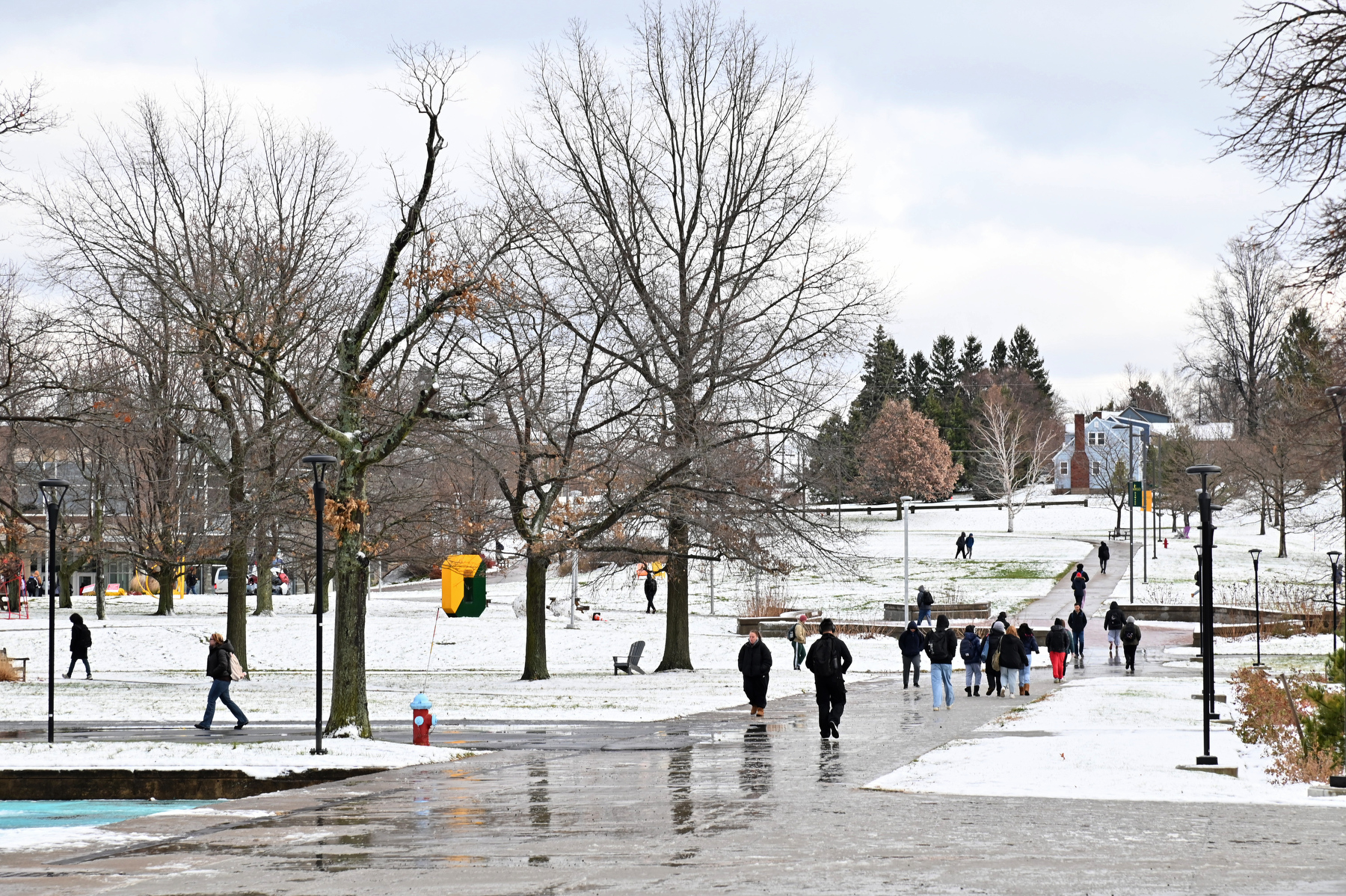 A light snow fell across the region at the end of the fall semester during final exams week. Pictured are students walking to their classes Dec. 12 along the quad near Marano Campus Center.