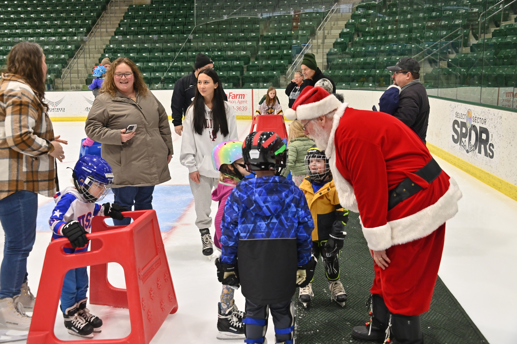 Santa Claus brings some holiday glee Dec. 6 to enthusiastic young skaters during the Holiday Skate with the Lakers. 