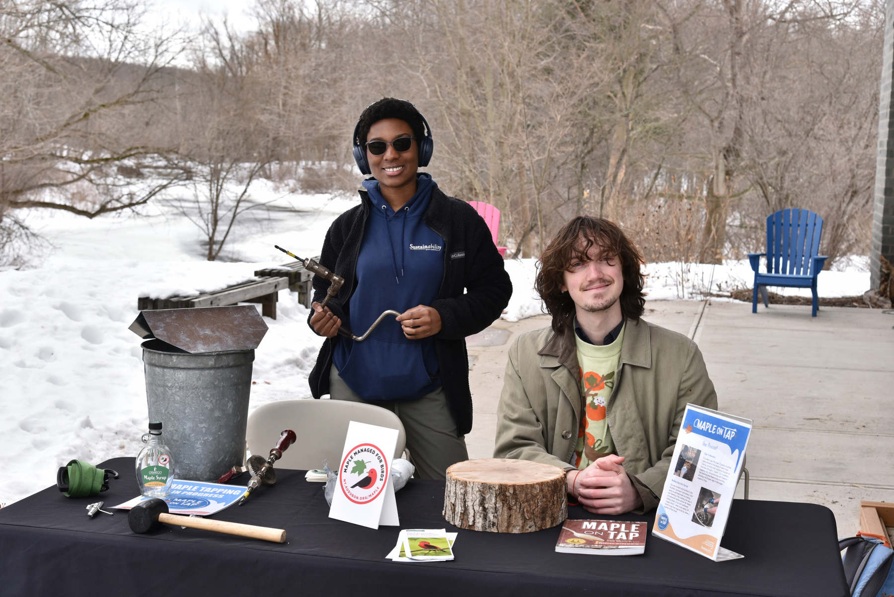 Among those taking part in “Fresh Air, Fresh Start” were Office of Sustainability interns Josephine Ragland (left), a junior mathematics major, and Barnaby Hurst (right), a senior biology major, display some maple tree tapping tools used to gather sap for making maple syrup.