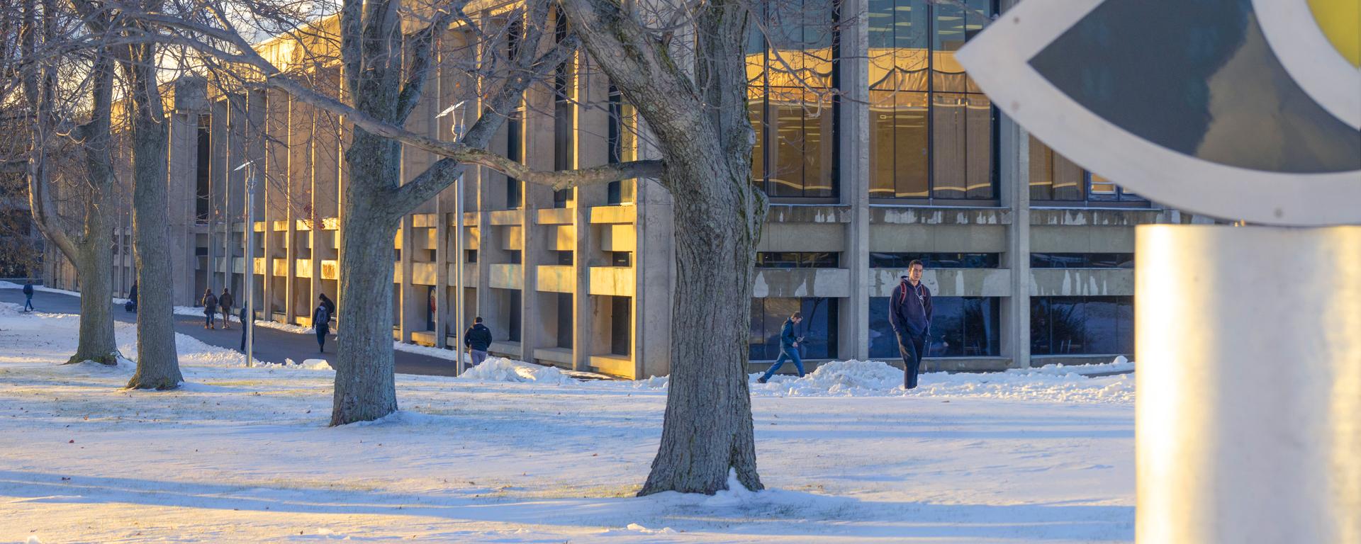 Snow-covered campus with students walking