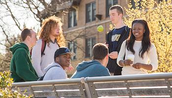 Three students walk across campus